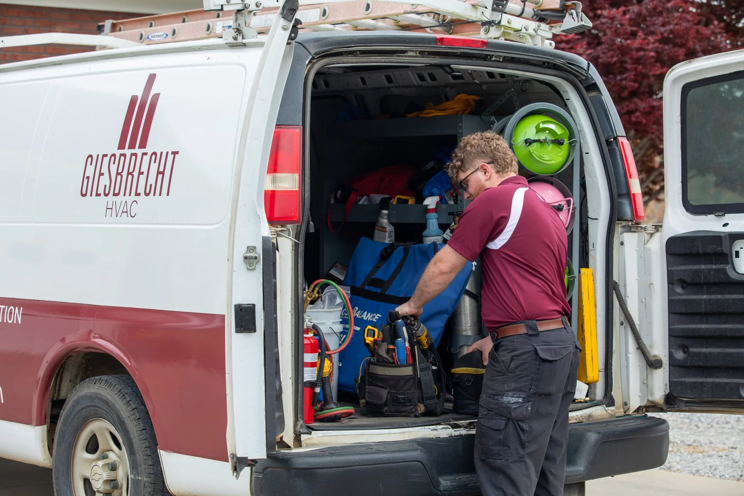 Giesbrecht HVAC technician repairing AC